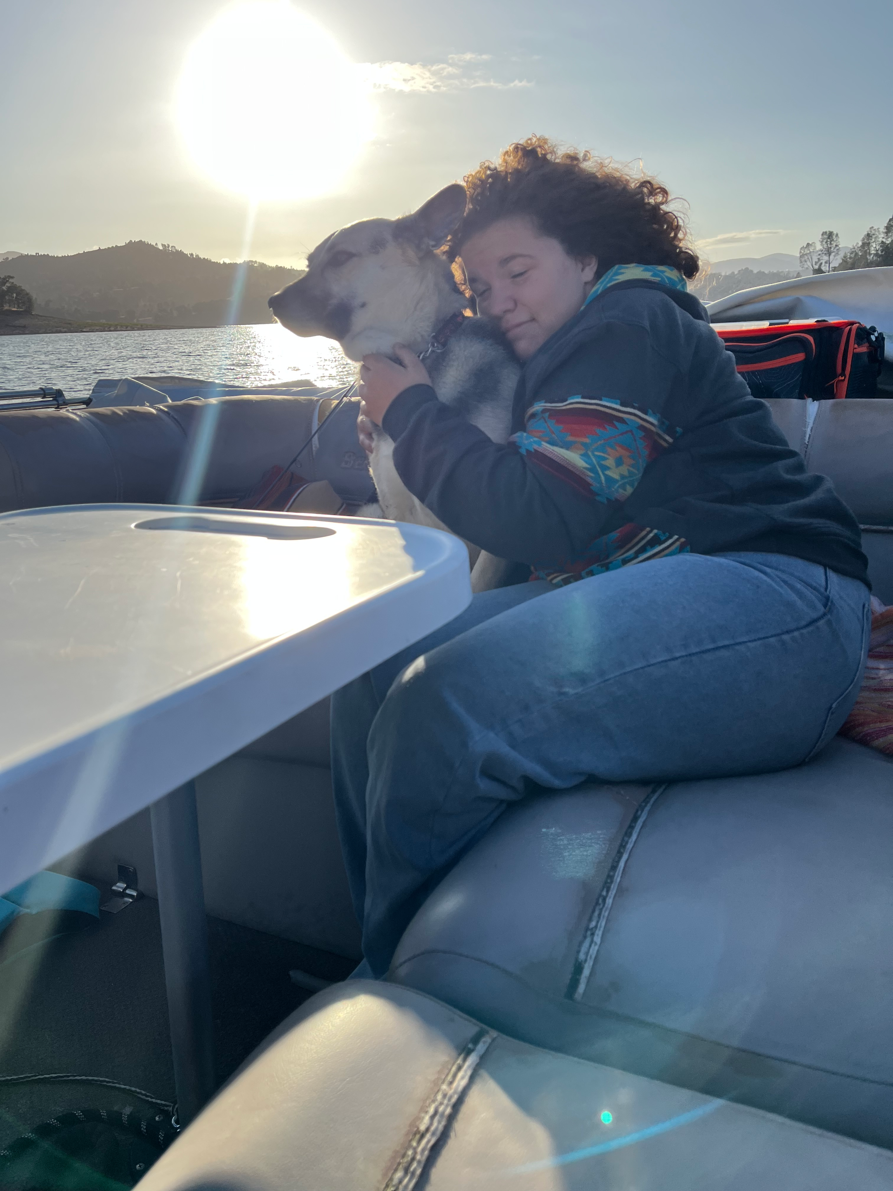 makenna and her dod, lady, sitting on the boat